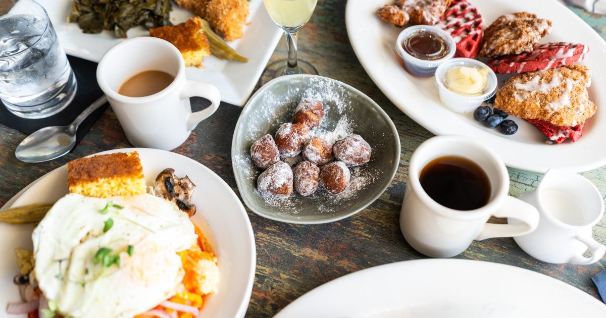 Bright morning breakfast spread with waffles, eggs, coffee at a local Durham cafe